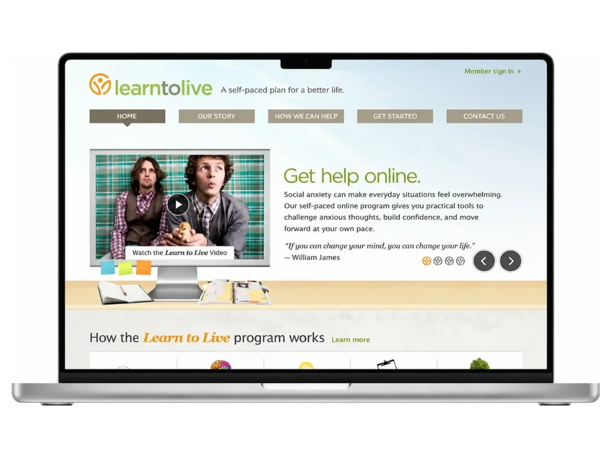 The Learn to Live marketing site on a silver laptop: the orange circle mark and green lowercase wordmark in the site header beside its tagline, a tan navigation row under it, and a Get help online headline next to a video still.