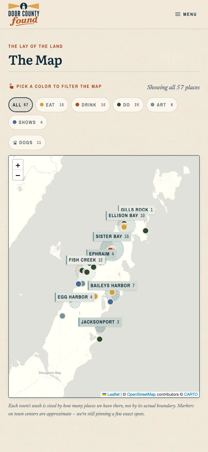 The map on a phone: filter chips reading All 57, Eat 15, Drink 10, Do 20, Art 8, Shows 4 and Dogs 11, above a map of the peninsula where every town carries its own count and a circle sized to it.
