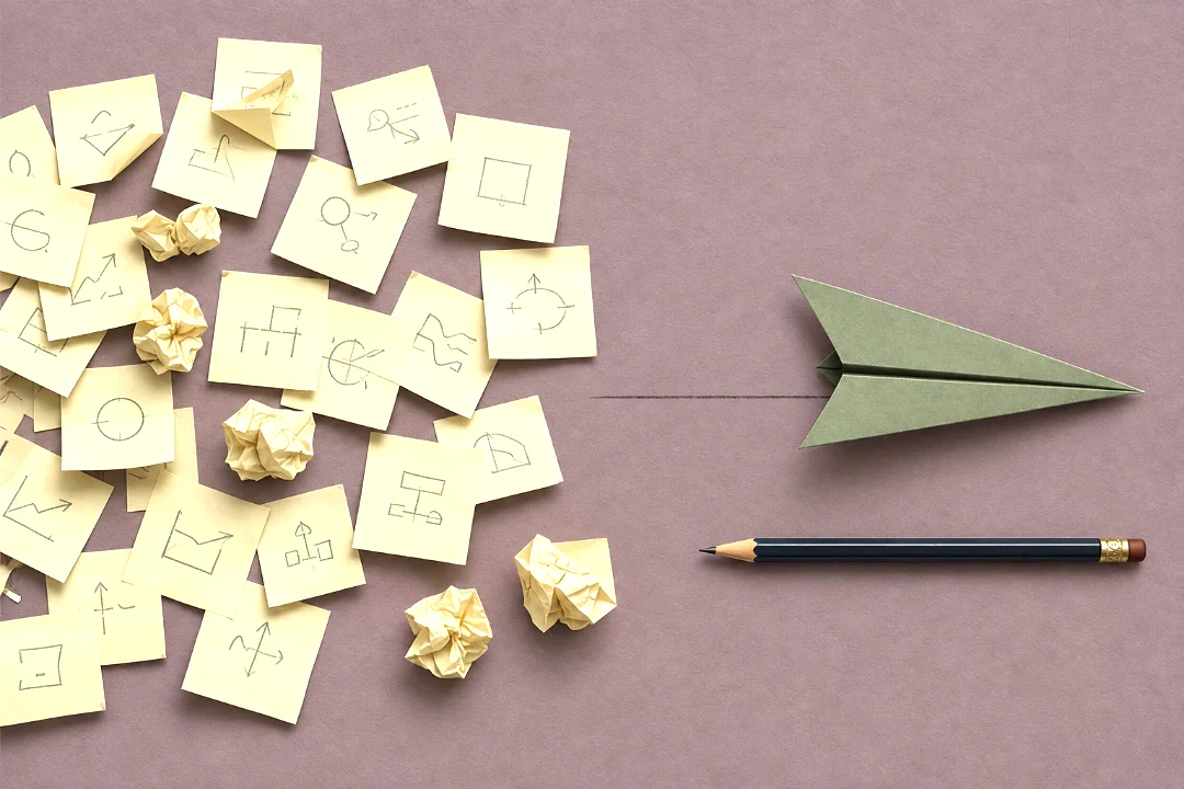 Dozens of sticky notes with small pencil sketches and a few crumpled into balls on a dusty plum surface, thinning out to the right where one crisp sage paper airplane sits on a pencil-drawn runway above a sharpened pencil