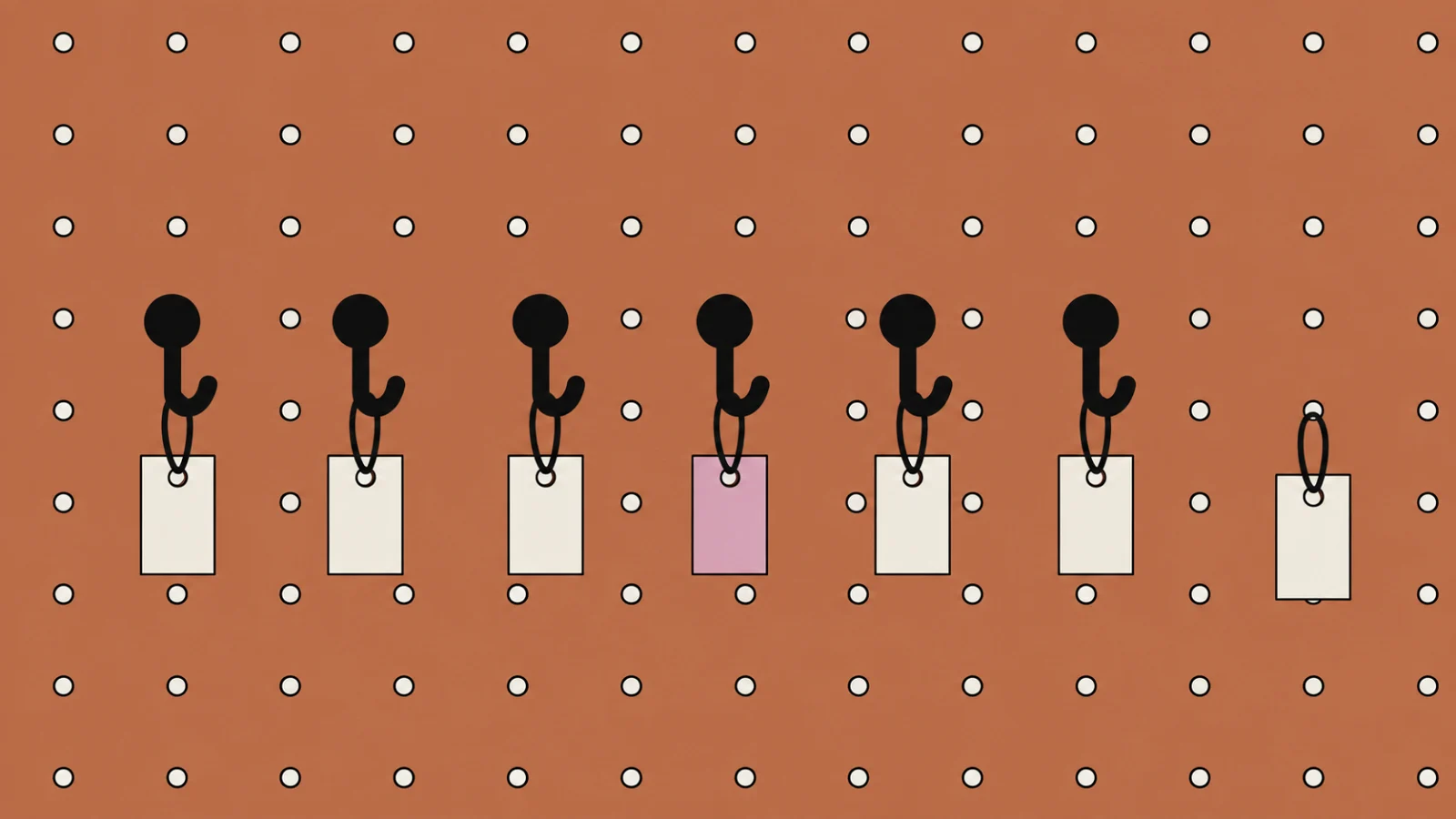 The terracotta pegboard with its row of six black hooks each holding a small cream tag, the fourth tag filled dusty rose, and a seventh cream tag hanging from a hole in the board to the right of the row where there is no hook.