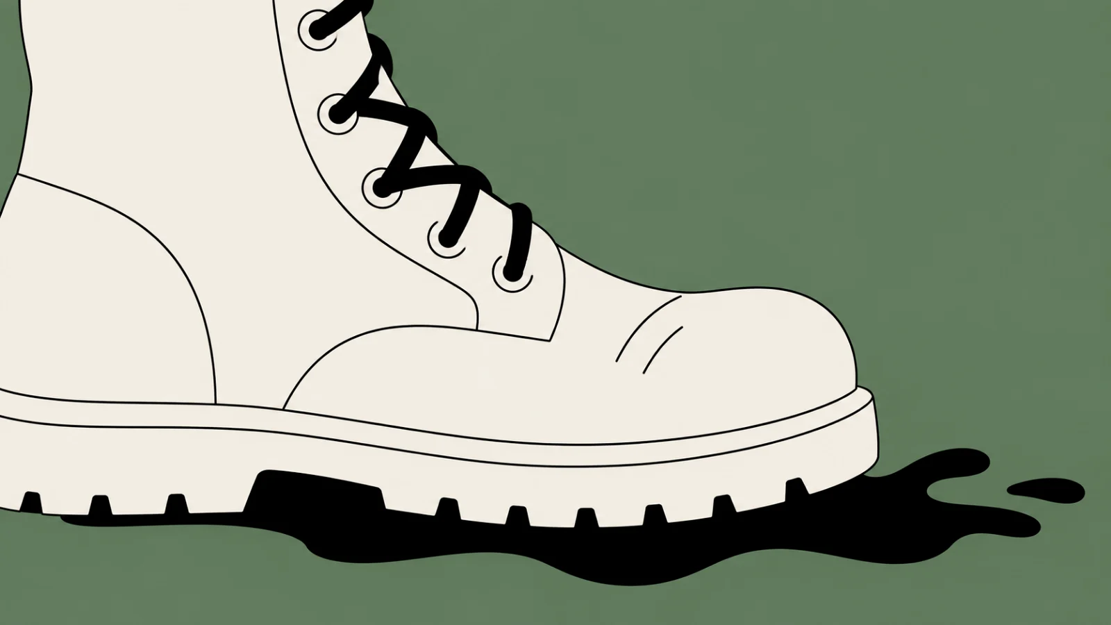 A cream work boot planted on a sage field, cropped by the left edge, with one black splash of mud spreading from under its sole.